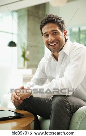 Smiling mixed race businessman in lobby, View Large Photo Image Stock Photography - Smiling mixed race businessman in lobby, . Fotosearch