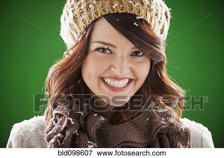 Stock Photo - Smiling mixed race woman covered with snowflakes. Fotosearch