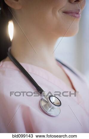 Stock Image - Stethoscope around Japanese nurse's neck. Fotosearch