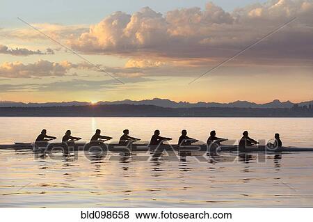 Team rowing boat in bay View Large Photo Image Stock Photo - Team rowing boat in bay. Fotosearch