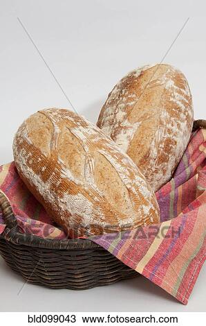 Two loaves of fresh bread in basket View Large Photo Image Stock Image - Two loaves of fresh bread in basket. Fotosearch