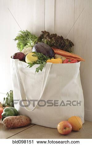 Stock Image - Variety of vegetables in reusable bag. Fotosearch