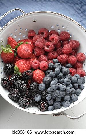 Stock Photograph - Various fresh berries in colander. Fotosearch