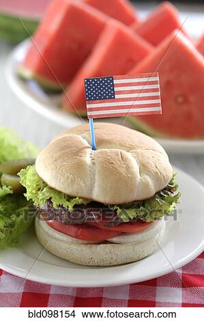 Picture - Watermelon and hamburger with American flag decoration. Fotosearch