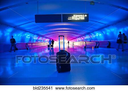 Stock Image - Abandoned suitcase in blue airport terminal. Fotosearch