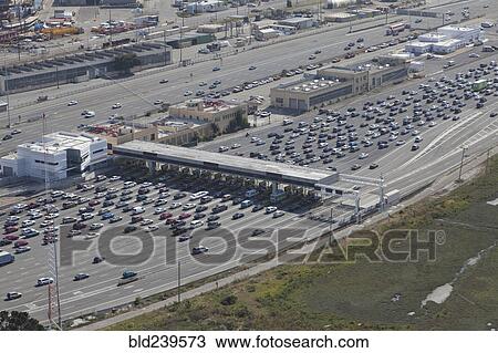 Stock Image - Aerial view of cars at toll plaza. Fotosearch