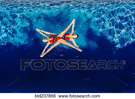 Aerial view of Caucasian synchronized swimmers View Large Photo Image Stock Photograph - Aerial view of Caucasian synchronized swimmers. Fotosearch