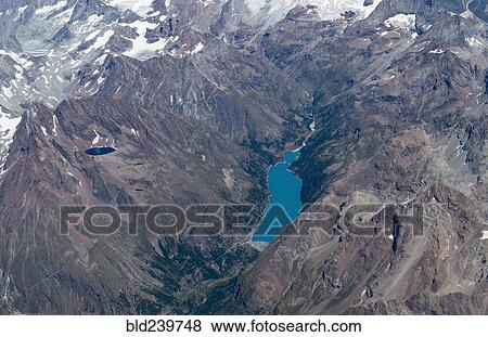 Aerial view of lakes in snowy mountain landscape View Large Photo Image Stock Photo - Aerial view of lakes in snowy mountain landscape. Fotosearch