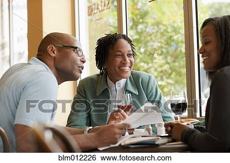 Stock Photograph - African American co-workers working in restaurant. Fotosearch