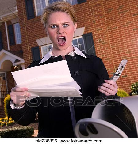 Angry woman reading mail at mailbox View Large Photo Image Stock Photograph - Angry woman reading mail at mailbox. Fotosearch