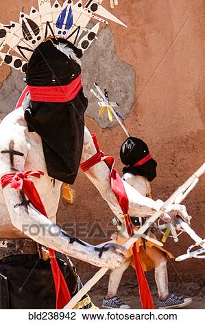 Stock Image - Apache man and boy wearing traditional regalia. Fotosearch