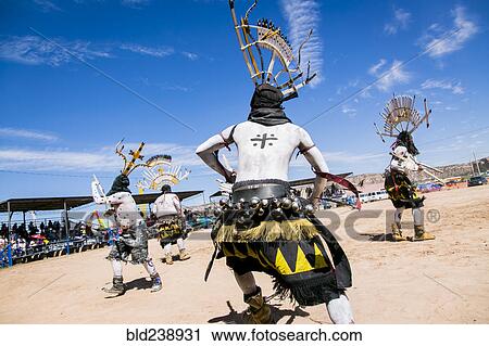 Stock Image - Apache men dancing in traditional regalia. Fotosearch