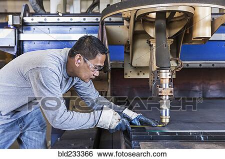 Asian worker fabricating metal in factory View Large Photo Image Stock Photograph - Asian worker fabricating metal in factory. Fotosearch