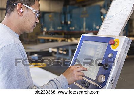 Asian worker using control panel in factory View Large Photo Image Stock Photo - Asian worker using control panel in factory. Fotosearch