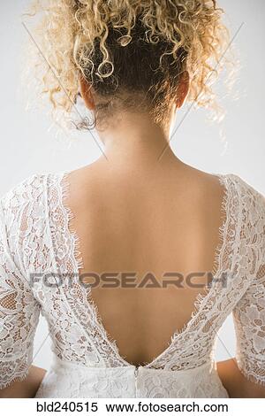Stock Photography - Back of Mixed Race woman wearing wedding dress. Fotosearch