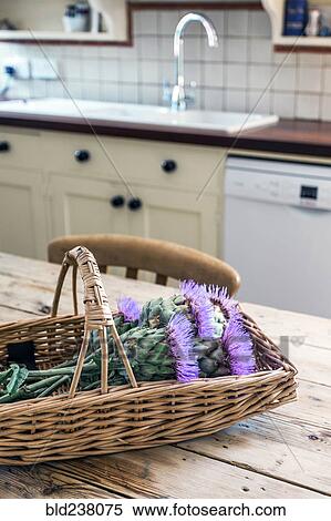 Basket of flowers in rustic domestic kitchen View Large Photo Image Stock Photography - Basket of flowers in rustic domestic kitchen. Fotosearch