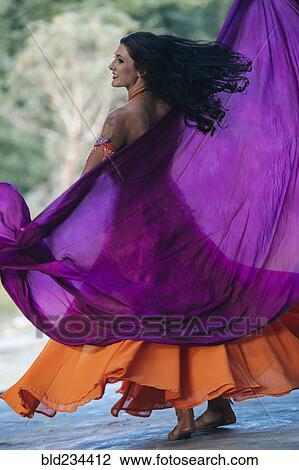 Belly dancer holding purple fabric View Large Photo Image Stock Image - Belly dancer holding purple fabric. Fotosearch