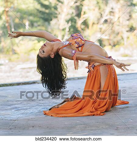 Belly dancer kneeling on stage View Large Photo Image Stock Image - Belly dancer kneeling on stage. Fotosearch