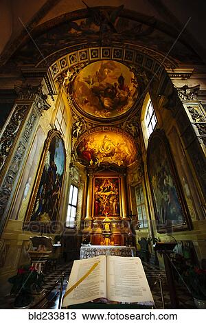 Stock Image - Bible on pedestal in ornate church. Fotosearch