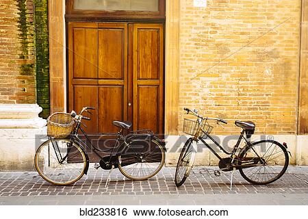 Bicycles parked near doorway View Large Photo Image Stock Photograph - Bicycles parked near doorway. Fotosearch