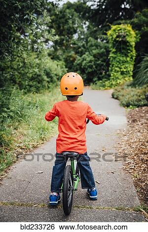 Black boy on bicycle wearing helmet View Large Photo Image Stock Photograph - Black boy on bicycle wearing helmet. Fotosearch