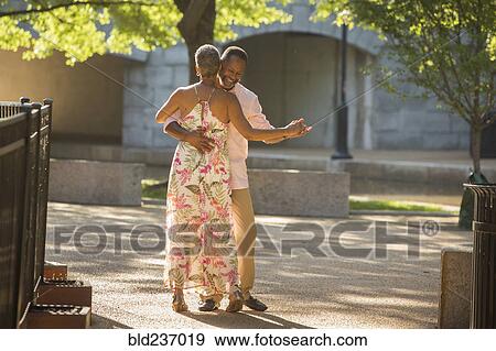 Stock Photo - Black couple dancing in park. Fotosearch