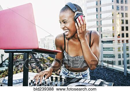 Black DJ laughing on urban rooftop View Large Photo Image Stock Photo - Black DJ laughing on urban rooftop. Fotosearch