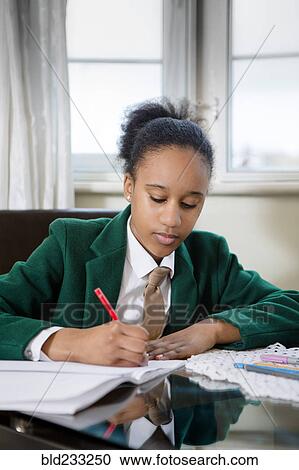 Black girl wearing school uniform doing homework View Large Photo Image Stock Image - Black girl wearing school uniform doing homework. Fotosearch
