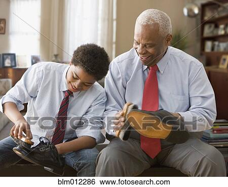 Black grandson and grandfather shining their shoes View Large Photo Image Stock Photograph - Black grandson and grandfather shining their shoes. Fotosearch