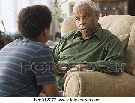 Black grandson talking with grandfather View Large Photo Image Stock Image - Black grandson talking with grandfather. Fotosearch