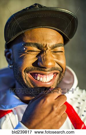 Stock Photo - Black man laughing with eyes closed. Fotosearch