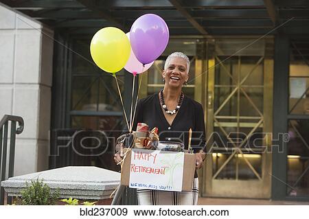 Black woman carrying belongings with happy retirement sign and balloons View Large Photo Image Stock Photo - Black woman carrying belongings with happy retirement sign and balloons. Fotosearch