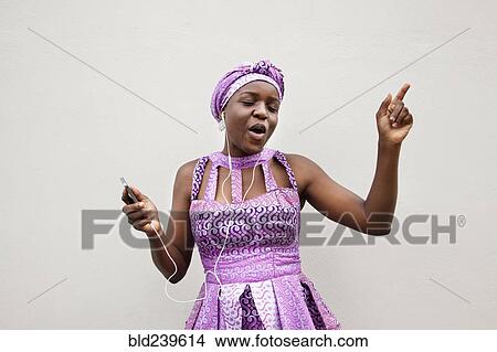 Black woman dancing to music on cell phone View Large Photo Image Picture - Black woman dancing to music on cell phone. Fotosearch