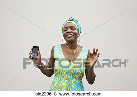 Black woman dancing to music on cell phone View Large Photo Image Stock Photo - Black woman dancing to music on cell phone. Fotosearch