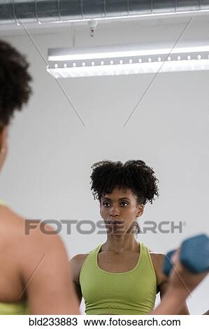 Black woman lifting dumbbells View Large Photo Image Stock Image - Black woman lifting dumbbells. Fotosearch