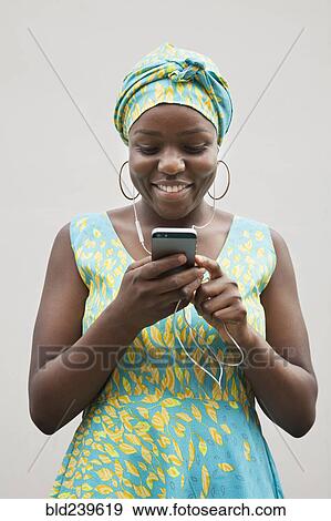 Black woman listening to music on cell phone View Large Photo Image Stock Photo - Black woman listening to music on cell phone. Fotosearch