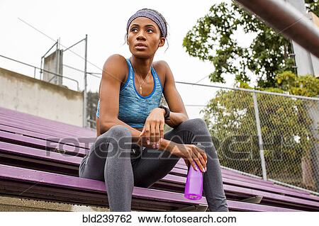 Black woman resting on bleachers View Large Photo Image Stock Image - Black woman resting on bleachers. Fotosearch