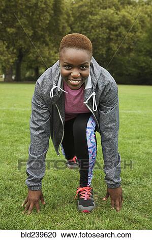 Black woman stretching legs in grass field View Large Photo Image Stock Image - Black woman stretching legs in grass field. Fotosearch