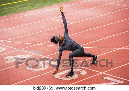 Black woman stretching on track starting line View Large Photo Image Stock Photography - Black woman stretching on track starting line. Fotosearch