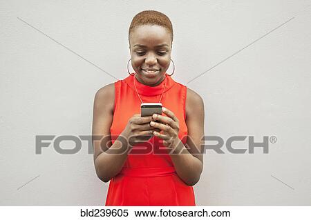 Black woman texting on cell phone View Large Photo Image Stock Photography - Black woman texting on cell phone. Fotosearch