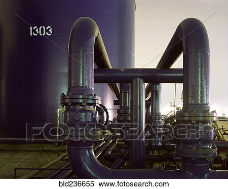 Blue industrial pipes and storage tank at sunset View Large Photo Image Stock Photography - Blue industrial pipes and storage tank at sunset. Fotosearch