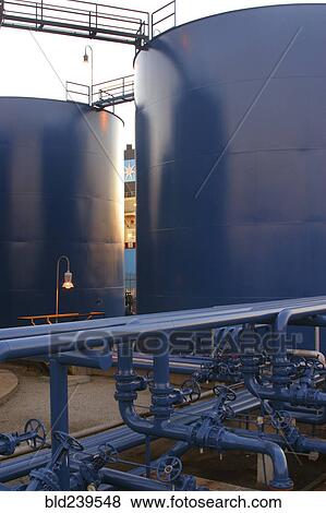Stock Photo - Blue pipes and storage tanks. Fotosearch