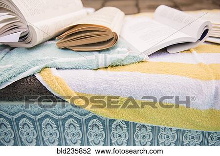 Books and towels at the edge of swimming pool View Large Photo Image Stock Image - Books and towels at the edge of swimming pool. Fotosearch