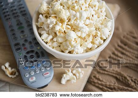 Bowl of popcorn and remote control View Large Photo Image Stock Image - Bowl of popcorn and remote control. Fotosearch