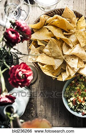 Stock Photograph - Bowl of tortilla chips and pico de gallo. Fotosearch