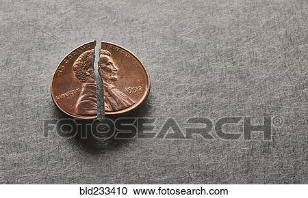 Stock Image - Broken penny. Fotosearch