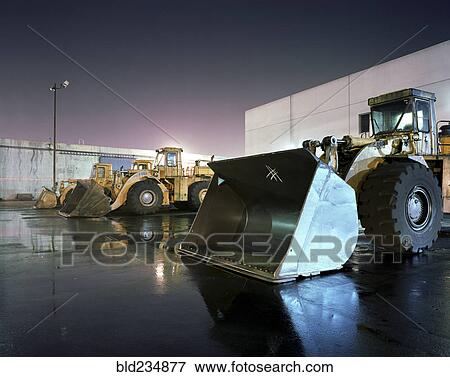 Bulldozers in parking lot View Large Photo Image Stock Photo - Bulldozers in parking lot. Fotosearch
