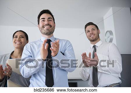 Business people applauding in office meeting View Large Photo Image Stock Photograph - Business people applauding in office meeting. Fotosearch