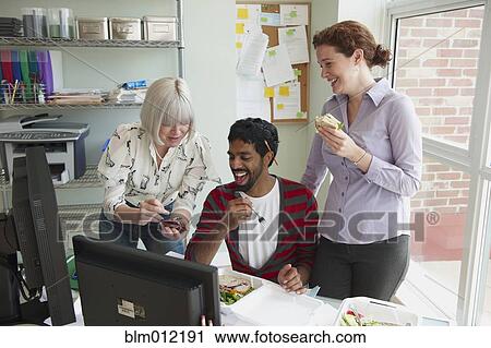 Business people working together in office over lunch View Large Photo Image Stock Image - Business people working together in office over lunch. Fotosearch