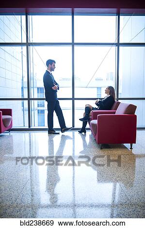 Businessman and businesswoman talking in office lounge View Large Photo Image Stock Photo - Businessman and businesswoman talking in office lounge. Fotosearch